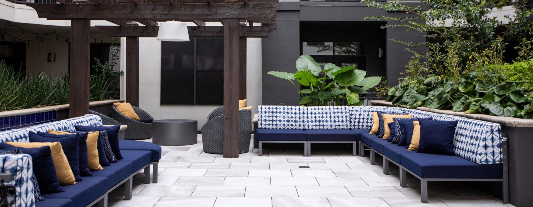 pergola covered patio with couches